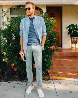 White Slip-on Sneakers Outfits For Men: Beyond stylish and comfortable, this relaxed combo of a light blue denim shirt and light blue chinos provides with variety. Look at how nice this outfit goes with white slip-on sneakers.