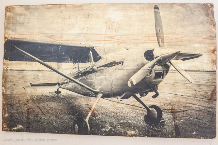 A black and white photo of an airplane on wood - photo gifts - https://digital-photography-school.com/how-to-transfer-prints-to-wood-an-awesome-photography-diy-project/