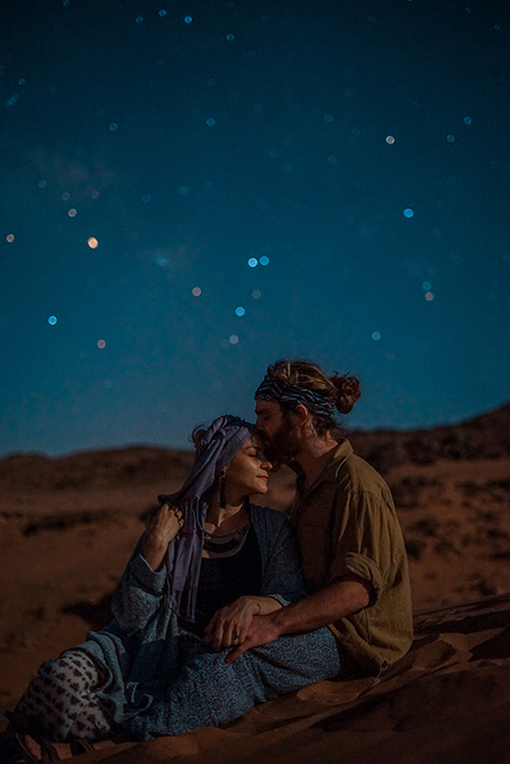 A couple sitting outside under the stars