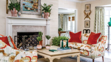 living room designed by James Farmer with grasscloth walls and fireplace.