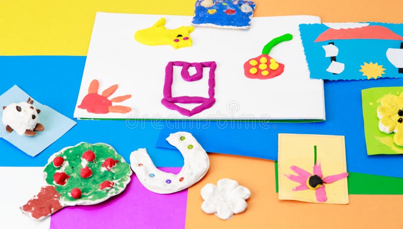 Baby crafts from play dough and colourful paper royalty free stock photography