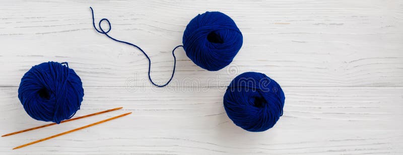 Background with knitting tools and classical blue skein yarn for starting a project, banner royalty free stock photo