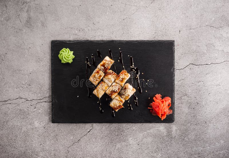 Baked sushi sushi on concrete background. Tasty baked sushi sushi on concrete background royalty free stock photography