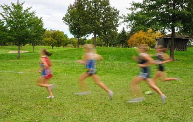 Blurred Girls Cross Country Runners. Intentionally Blurred Image of Girls Running at a High School Cross Country Meet royalty free stock photo