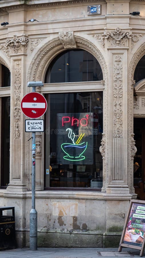 Bristol, UK - February 12 2020: Neon sign in the window of Pho cafe Vietnamese restaurant on Clare Street stock images