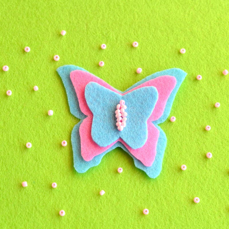 Butterfly decor sewn from pink and blue felt. Spring or summer simple DIY idea for kids stock image