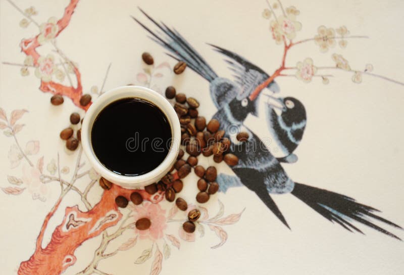 China specialty coffee concept. Black coffee in white cup. On chinese pattern background. Top view. China Yunnan specialty coffee concept. Black coffee in white royalty free stock image
