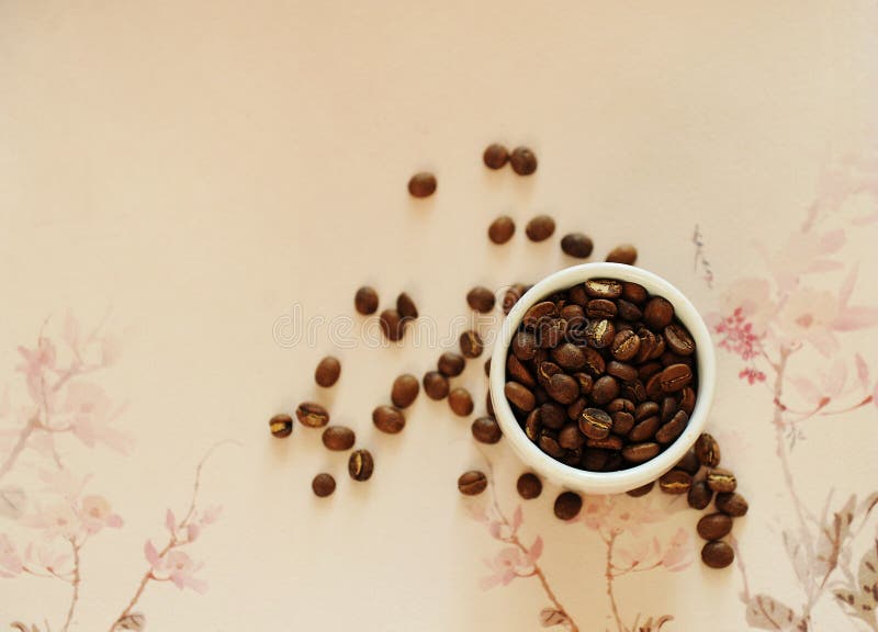 China specialty coffee concept. Roasted bean in white cup and on traditional chinese pattern background. Top view. China Yunnan specialty coffee concept. Roasted royalty free stock images
