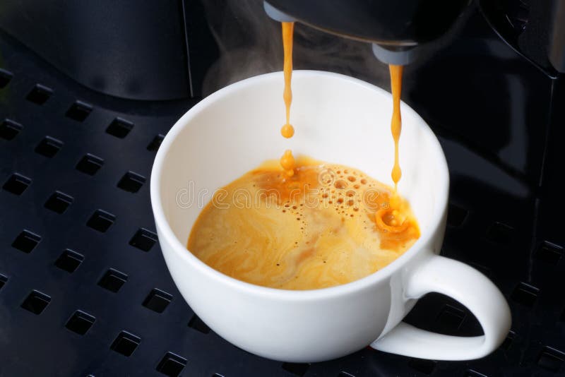 Closeup espresso preparation in coffee machine stock images