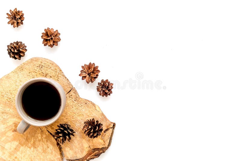Coffee on wooden sawcut and pine cone pattern for blog on white background top view mock up. Cup of coffee on wooden sawcut and pine cone pattern for blog title stock photos