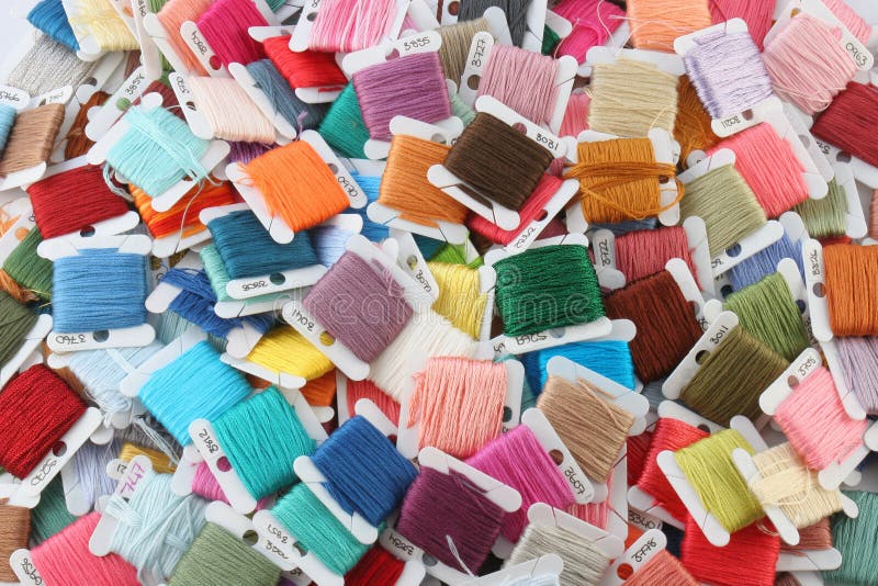 Colorful Embroidery Thread. Randomly colored and stacked pile of Embroidery thread cards. Standard colour numbers showing on some cards stock photo