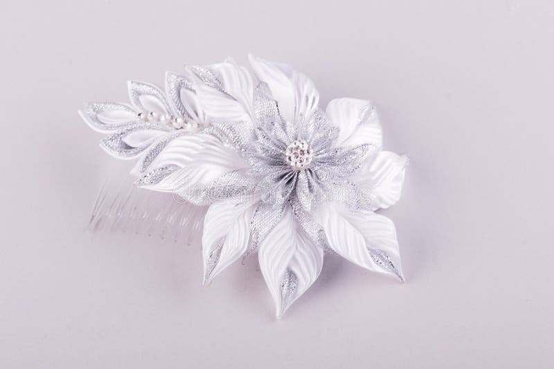 Corrugated flower petal hair clip. Beautiful handmade wedding hair clip in the shape of corrugated flower petals using the kanzashi technique stock photography