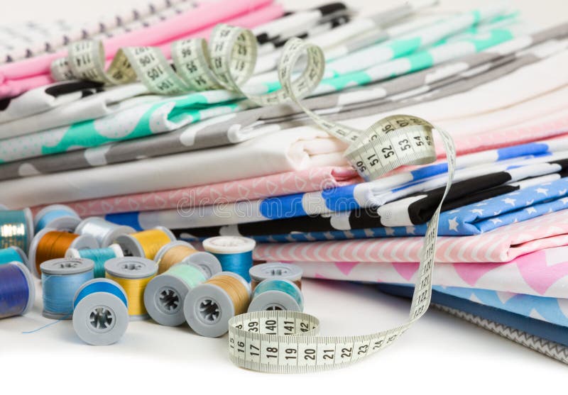Cotton fabric material, tailor measurement tape and spools of co royalty free stock photos