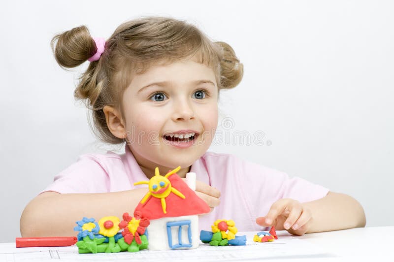 Creative playing with plasticine. Little girl playing with plasticine royalty free stock photography