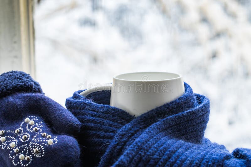 Cup Of Hot Coffee Or Tea In Blue Knitted Scarf And Mittens With Pattern. White Cup Of Hot Coffee Or Tea In Blue Knitted Scarf And Mittens With Pattern Of Beads stock images