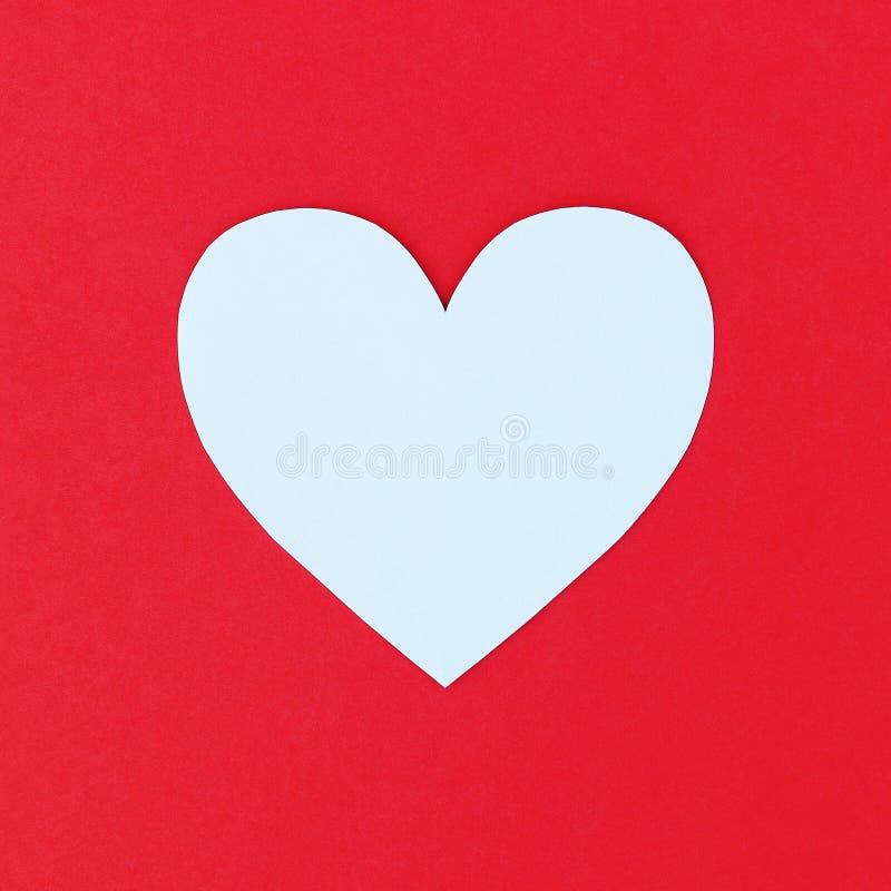 design of cutting white paper heart on red paper background stock image