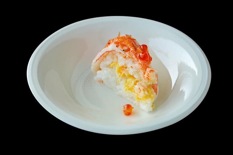 A piece of Salmon cake on white round plate. Die cut of Salmon sushi cake on white plate on black background isolated stock images