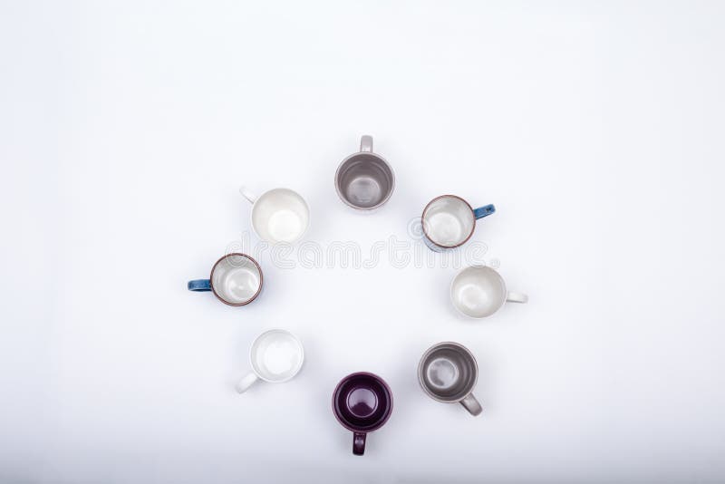 Eight empty coffee cups arranged in round pattern, on w. Hite background with copy space royalty free stock images