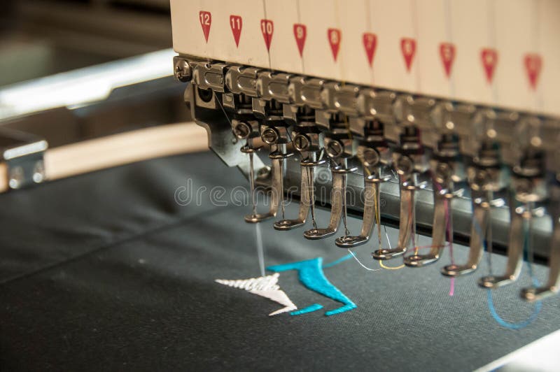 Embroidery machine stiching. A logo into clothing stock images