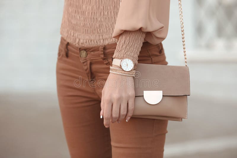 Fashion look autumn woman outfit. Stylish women`s beige handbag. royalty free stock photo