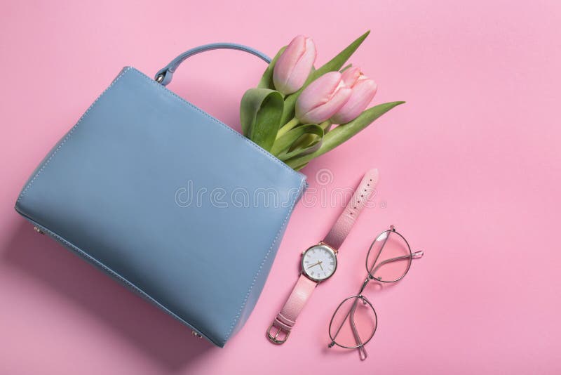 Flat lay composition with stylish woman`s handbag and spring flowers stock photo
