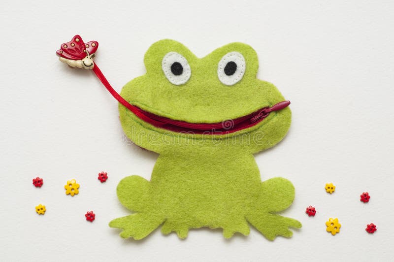Funny felt toy. Green frog caught a butterfly. Handmade toy. stock photo