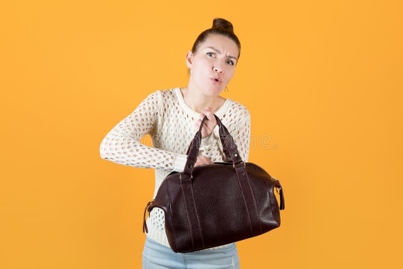 Girl pulls something out of a woman s handbag with effort royalty free stock image