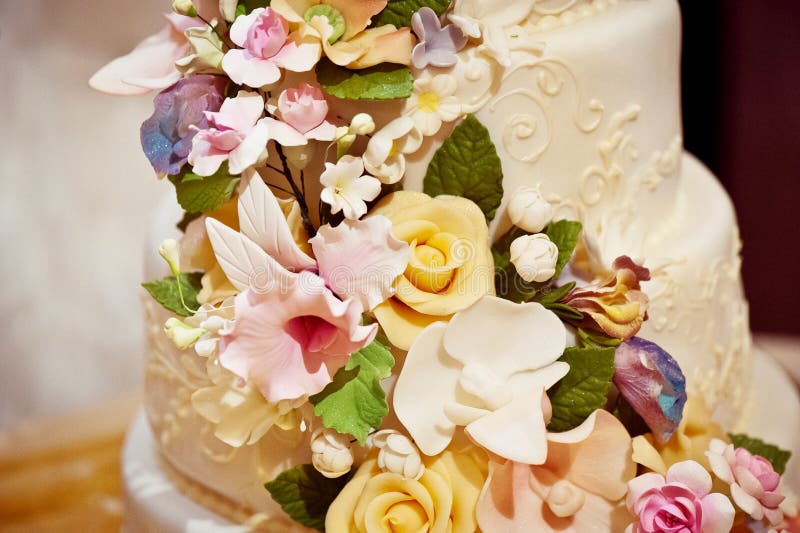 Gorgeous cream wedding cake with roses in 2 tiers flowers from mastic stock images