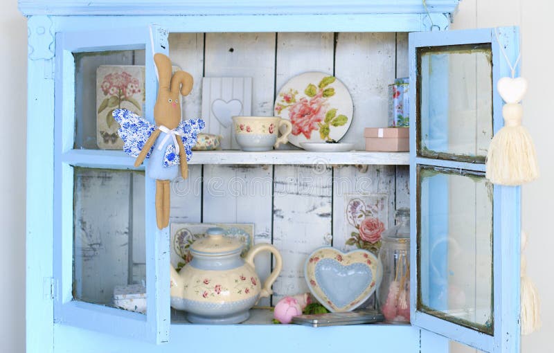 Vintage interior of retro, vintage wooden light blue sideboard and the old beautiful set of dishes stock image