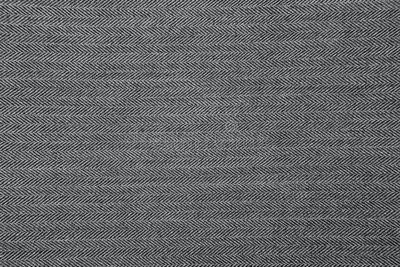 Grey herringbone fabric pattern texture background. Closeup royalty free stock photography
