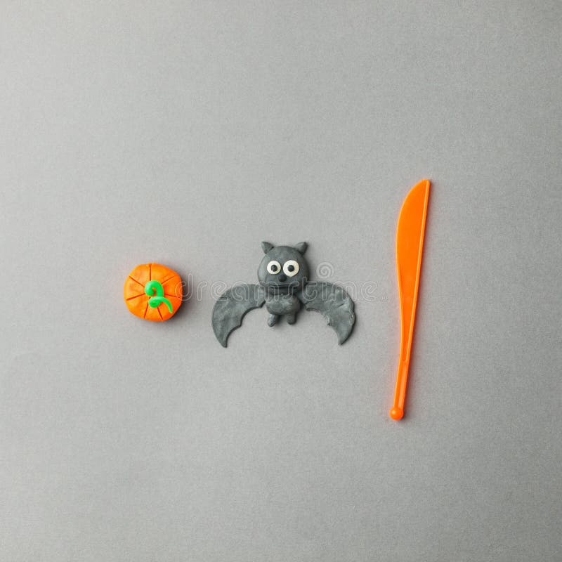 Handmade plasticine set for seasonal holiday Halloween and autumn days -  pumpkin and bat, creative DIY idea for kids, minimal stock photo