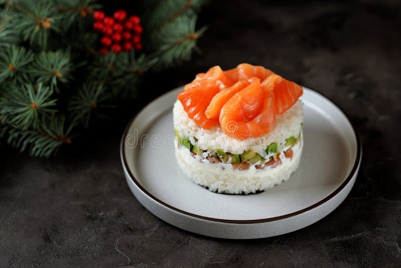 Homemade sushi cake with lightly salted salmon, avocado, soft cheese and seaweed. Christmas background. Food royalty free stock photos