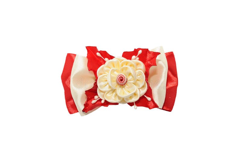 Kanzashi. Beige artificial flower on a red bow isolated on white stock photography