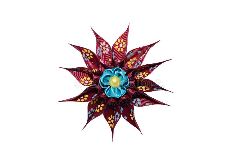 Kanzashi. Blue artificial flower on maroon star isolated on whit. E royalty free stock photos
