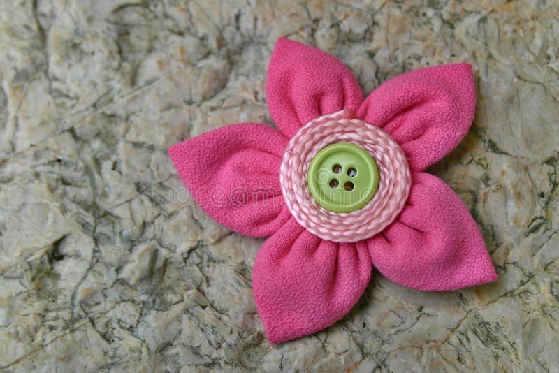 Kanzashi fabric flower. Kanzashi are hair ornaments used in traditional Japanese hairstyles. The term kanzashi is sometimes applied to the folded cloth flowers stock photo