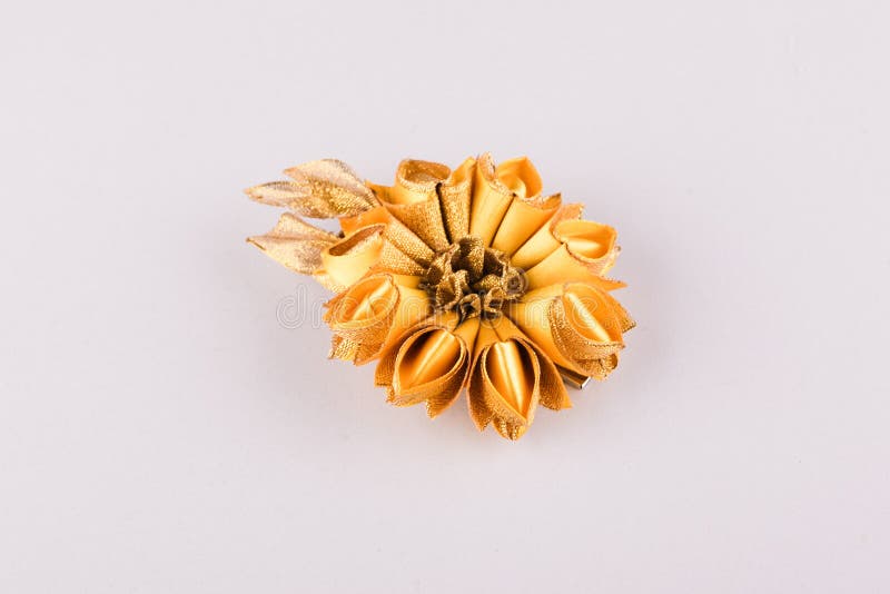 Kanzashi handmade elegant hair clip. Made of golden ribbons in the shape of a flower stock image