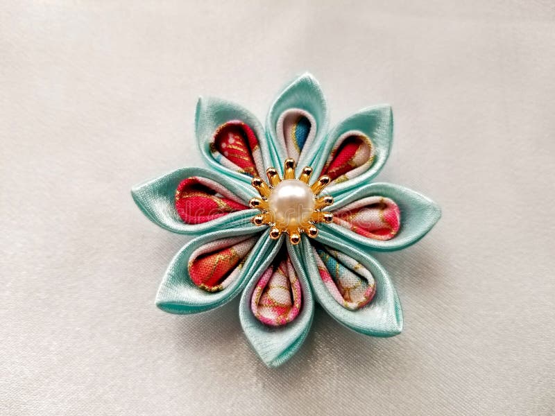 Kanzashi Handmade Fabric Flower -17. Japanese kanzashi hand made flower constructed from kimono material and displayed on an ivory background stock photography