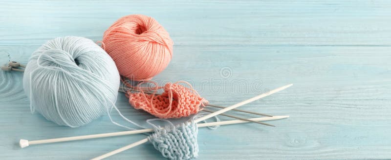 Knitting wool and knitting needles in pastel blue and pink colors royalty free stock photo