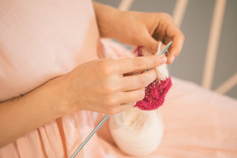 Lovely knitting Women`s hands, Relaxed pink colored mood hobby. enjoyable leisure meditation. Knitting Women`s hands, Relaxed pink colored mood hobby. enjoyable stock photo
