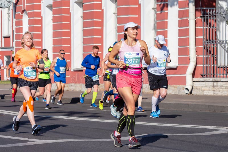 Marathon girls.  Runners of different ages and gender. St. Petersburg, Russia - June 30, 2019: 30th International Marathon - White Nights. Marathon girls royalty free stock photography