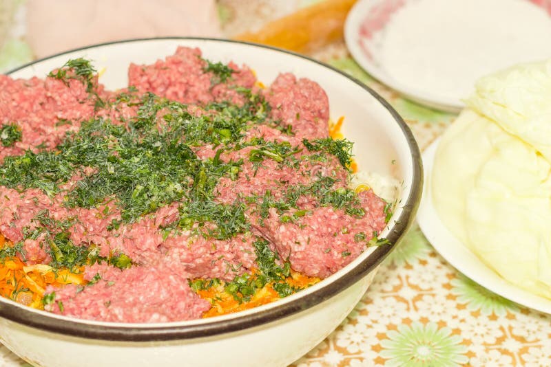 Meat filling in big bowl during preparation of stuffed dish stock photos