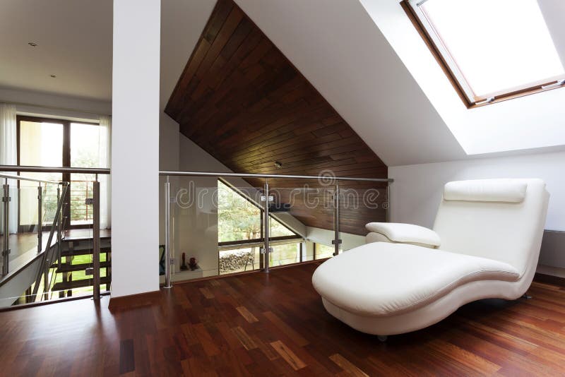 Mezzanine with armchair. Wooden attic with corner for rest, stylish mezzanine royalty free stock image