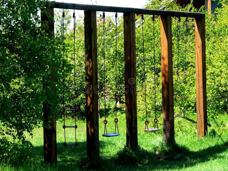 Photo with the architectural construction of wooden swings made of natural timber stock photography