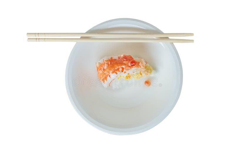 A piece of Salmon cake on white round plate. Top view of Die cut of Salmon sushi cake and shopsticks on white plate on white background isolated stock images