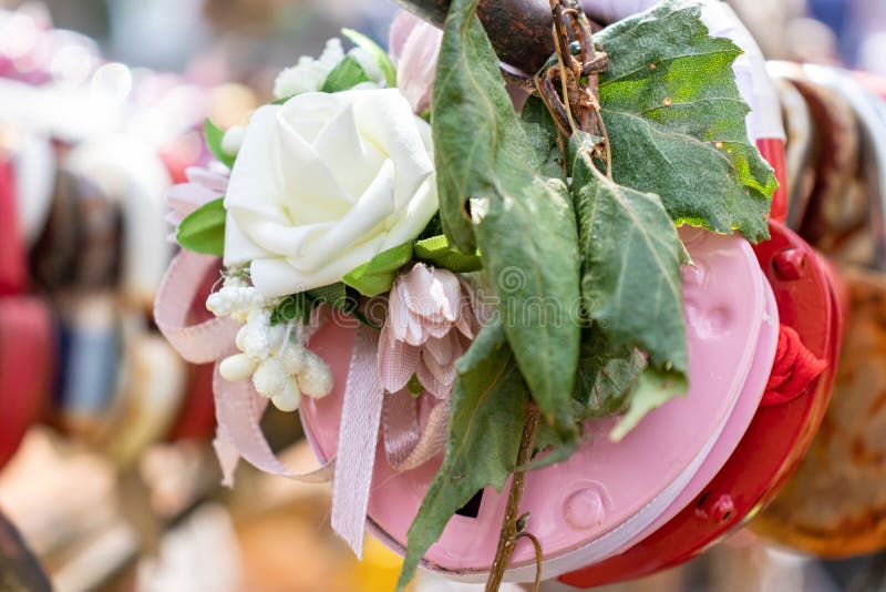 Pink wedding lock, castle on a wedding tree with a decorative kanzashi flower and a birch branch with green leaves as a symbol of. Eternal love and family royalty free stock photo
