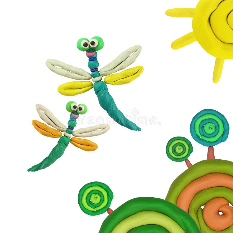 Plasticine dragonflies. Plasticine flying around the sun summer dragonflies royalty free stock image