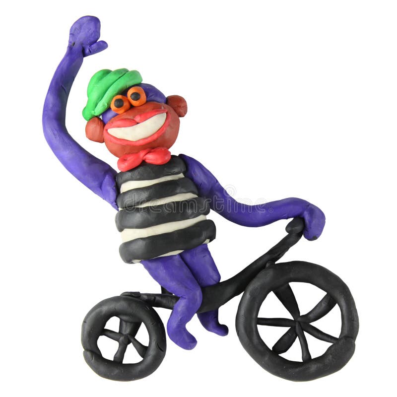 Plasticine monkey on the bicycle. On a white background royalty free stock photos