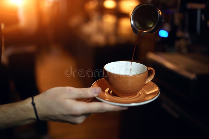 Preparation method. guy pouring cold brew coffee stock image