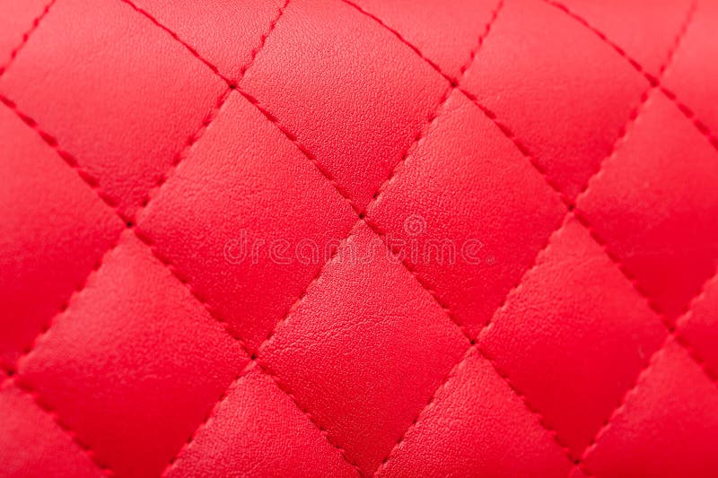 Red leather pattern stitched squares with thread seam. stock photography