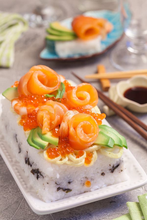 Salmon Sushi Cake. With shrimp, red caviar and avocado stock photos